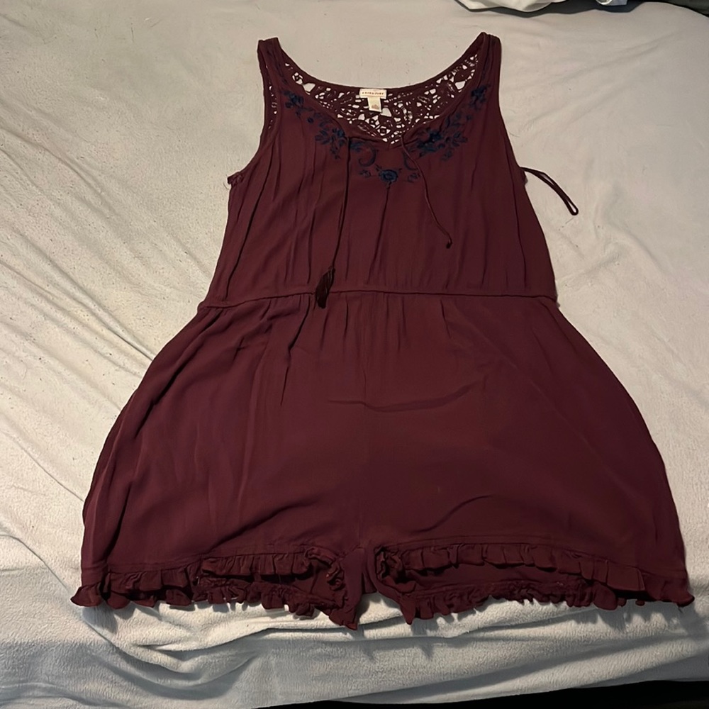 romper, one tassel is ripped off